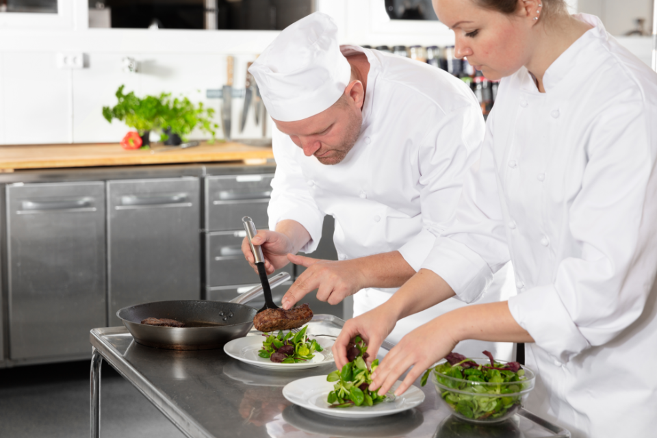 male and female chef in a kitchen